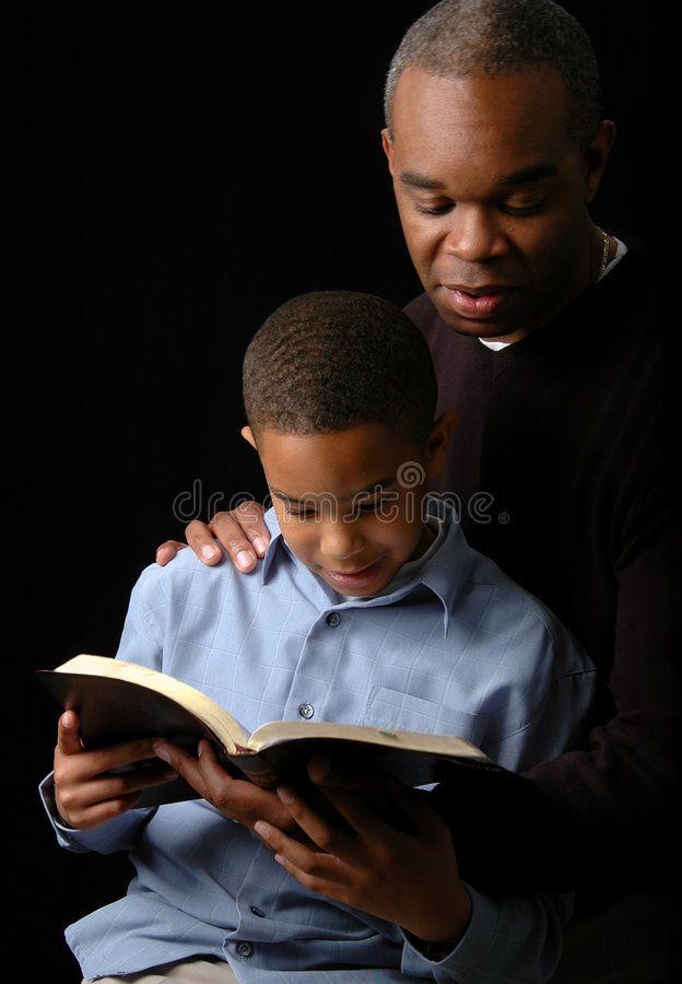 Black Dad Reading Book To His Son