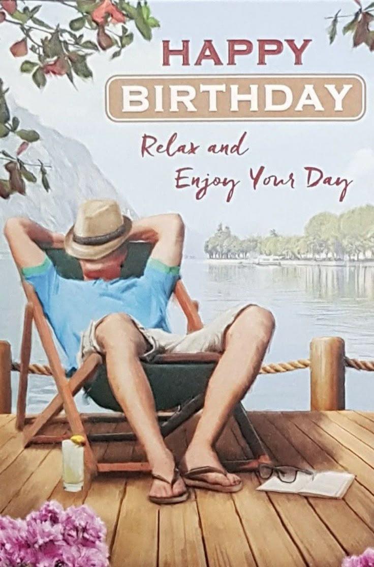 Dad relaxing in hammock with book and drink
