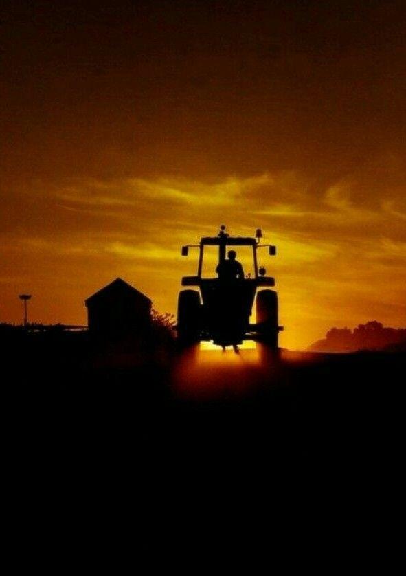 Farmer Tractor at Sunset