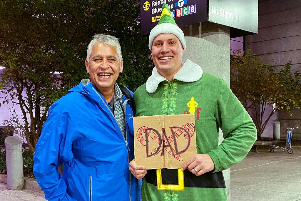 Father and son wearing matching Elf movie t-shirts
