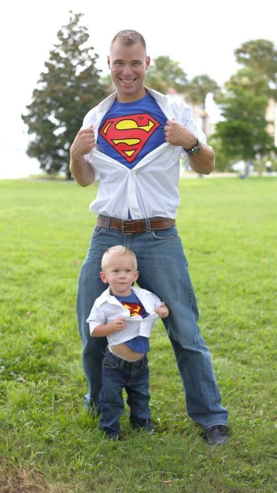 Father and daughter wearing matching superhero t-shirts.