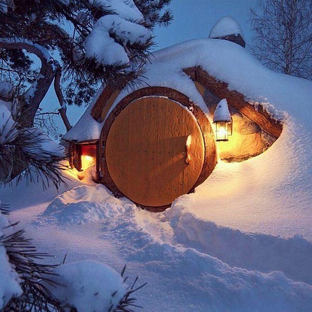 the shire covered in snow with christmas lights