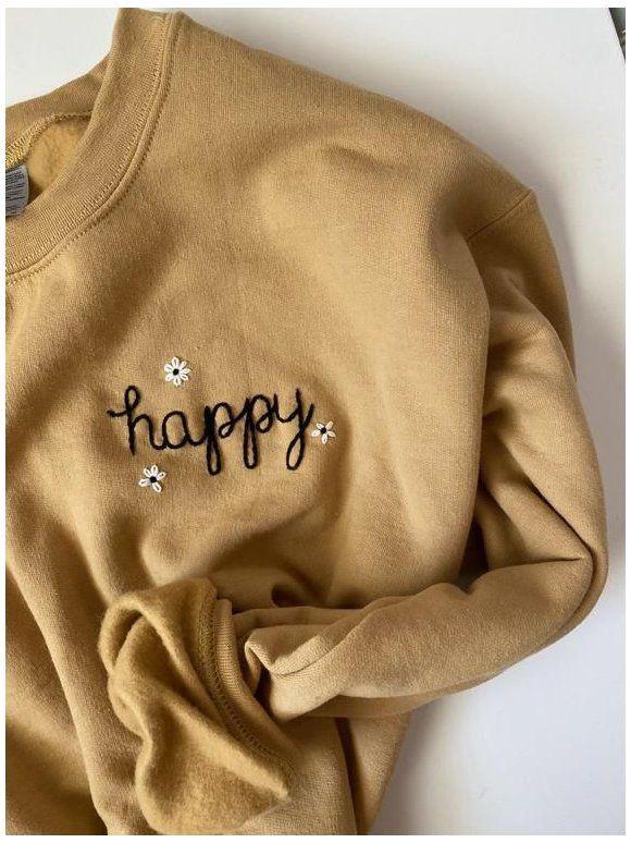 Mother and daughter smiling and wearing matching personalized hoodies with their names on the back.