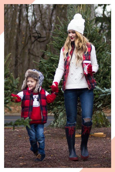 Mom and daughter wearing matching plaid Thanksgiving shirts outdoors