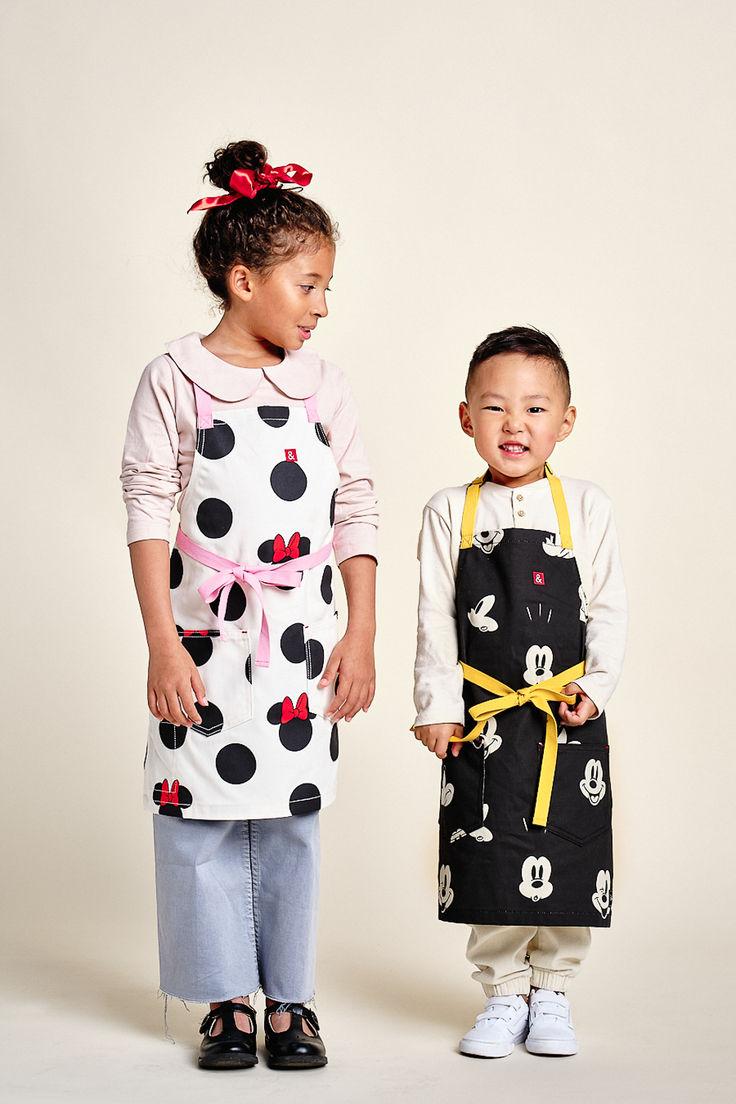 Mom and daughter wearing matching Thanksgiving aprons in the kitchen