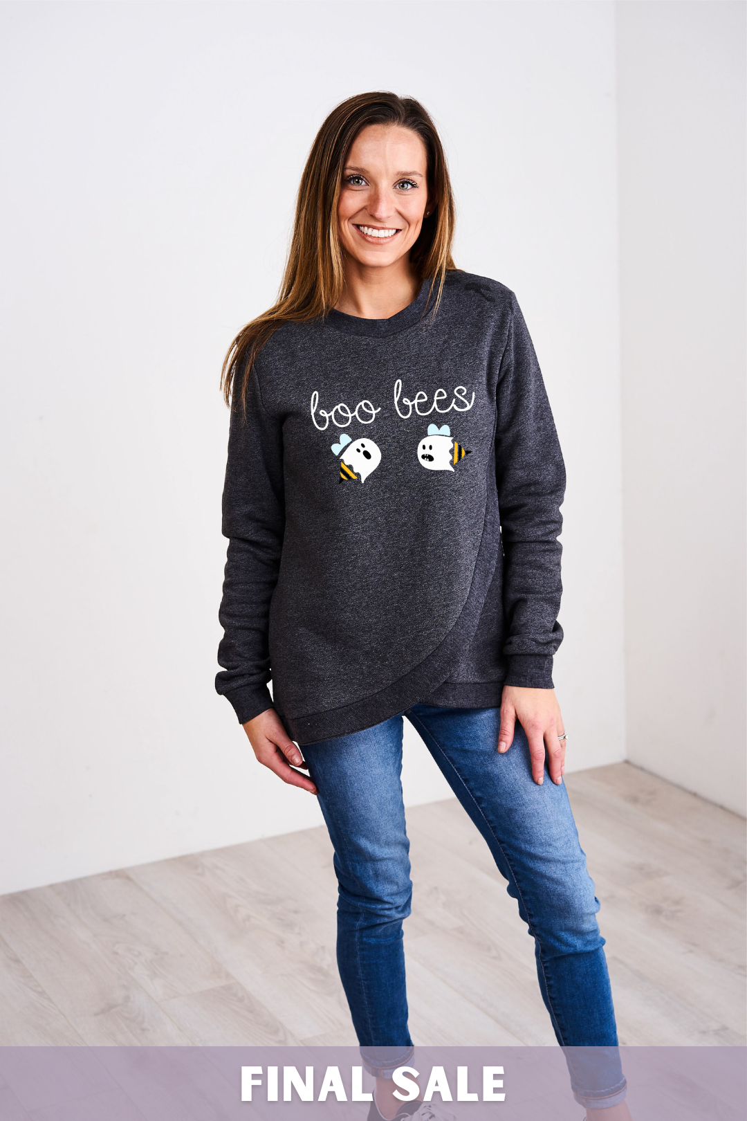 A mother wearing a boo bees nursing shirt while breastfeeding