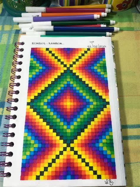 One hundred colorful Lego bricks arranged in a grid pattern on a t-shirt