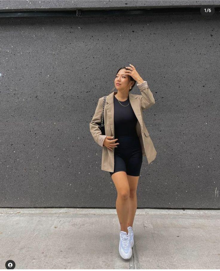 Woman wearing reformation love your mother hoodie with jeans and sneakers